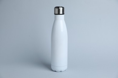 Photo of One white water bottle on light grey background