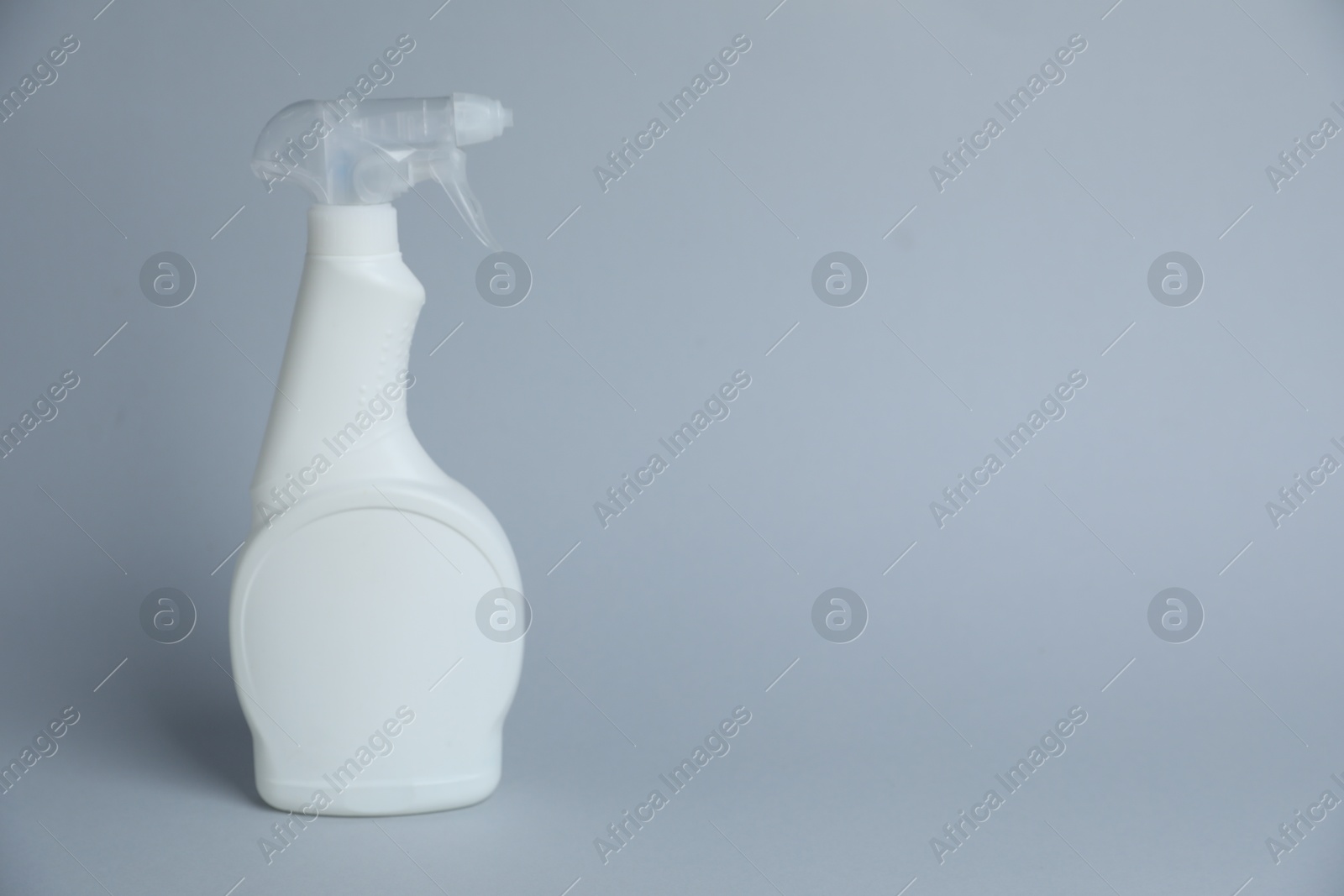 White spray bottle of cleaning product on light grey background, space for text Photo of White spray bottle of cleaning product on light grey background, space for text