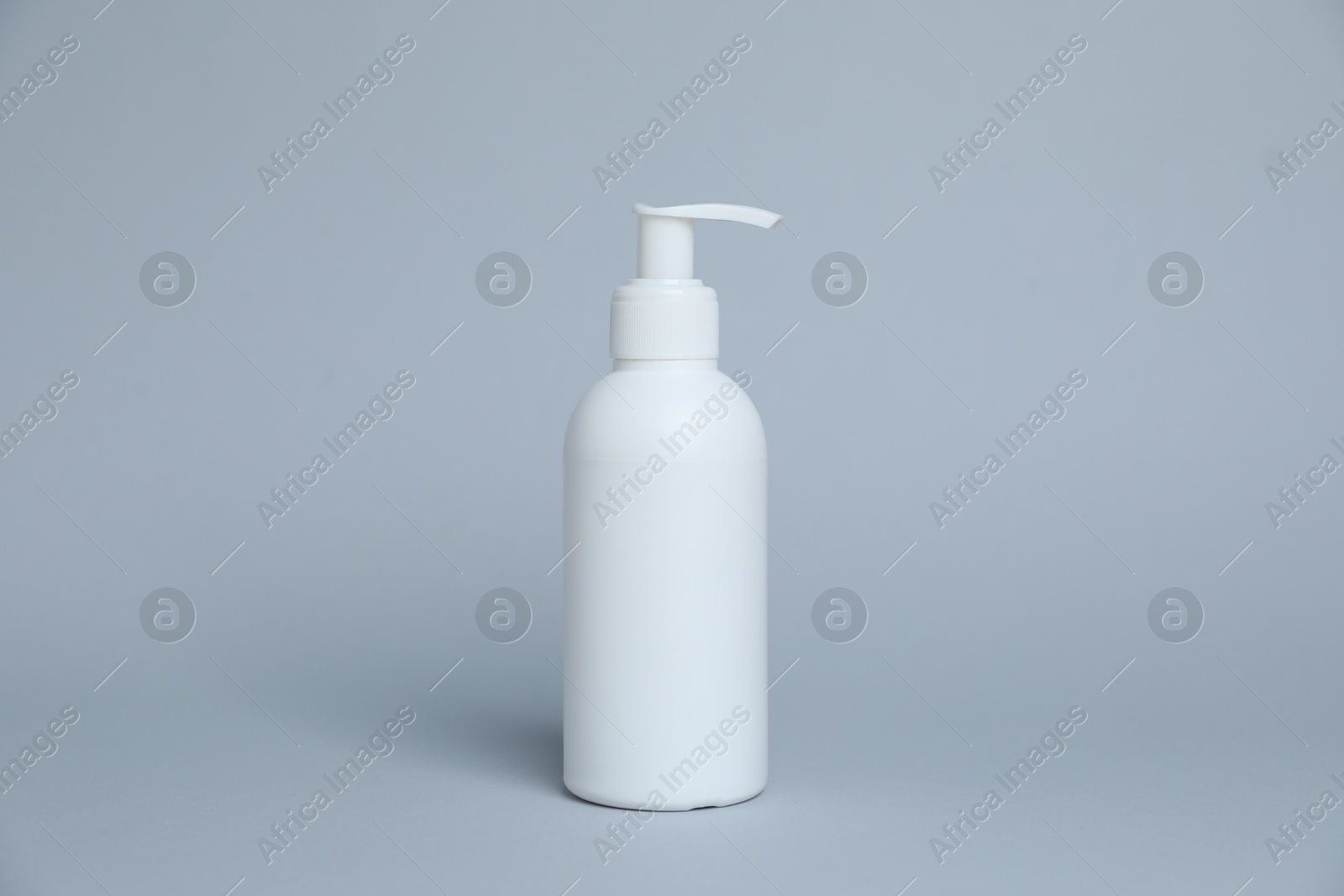 Photo of One white bottle of cosmetic product on light grey background