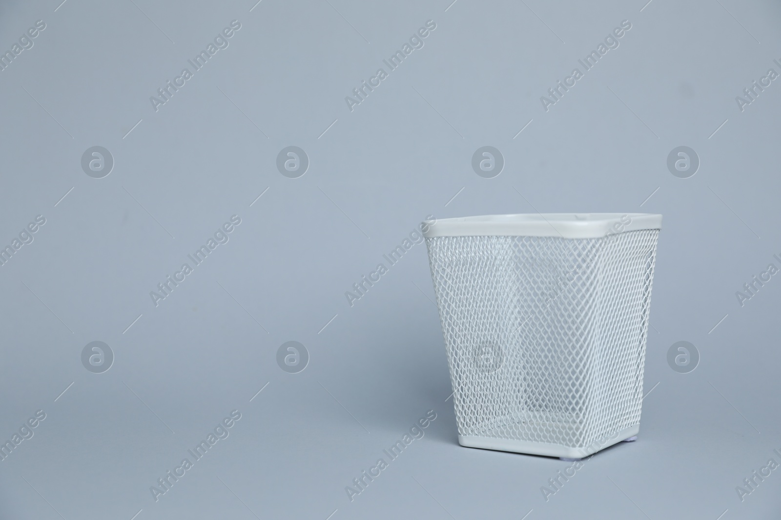 White metal holder on light grey background, space for text Photo of White metal holder on light grey background, space for text