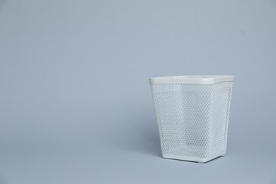 Photo of White metal holder on light grey background, space for text