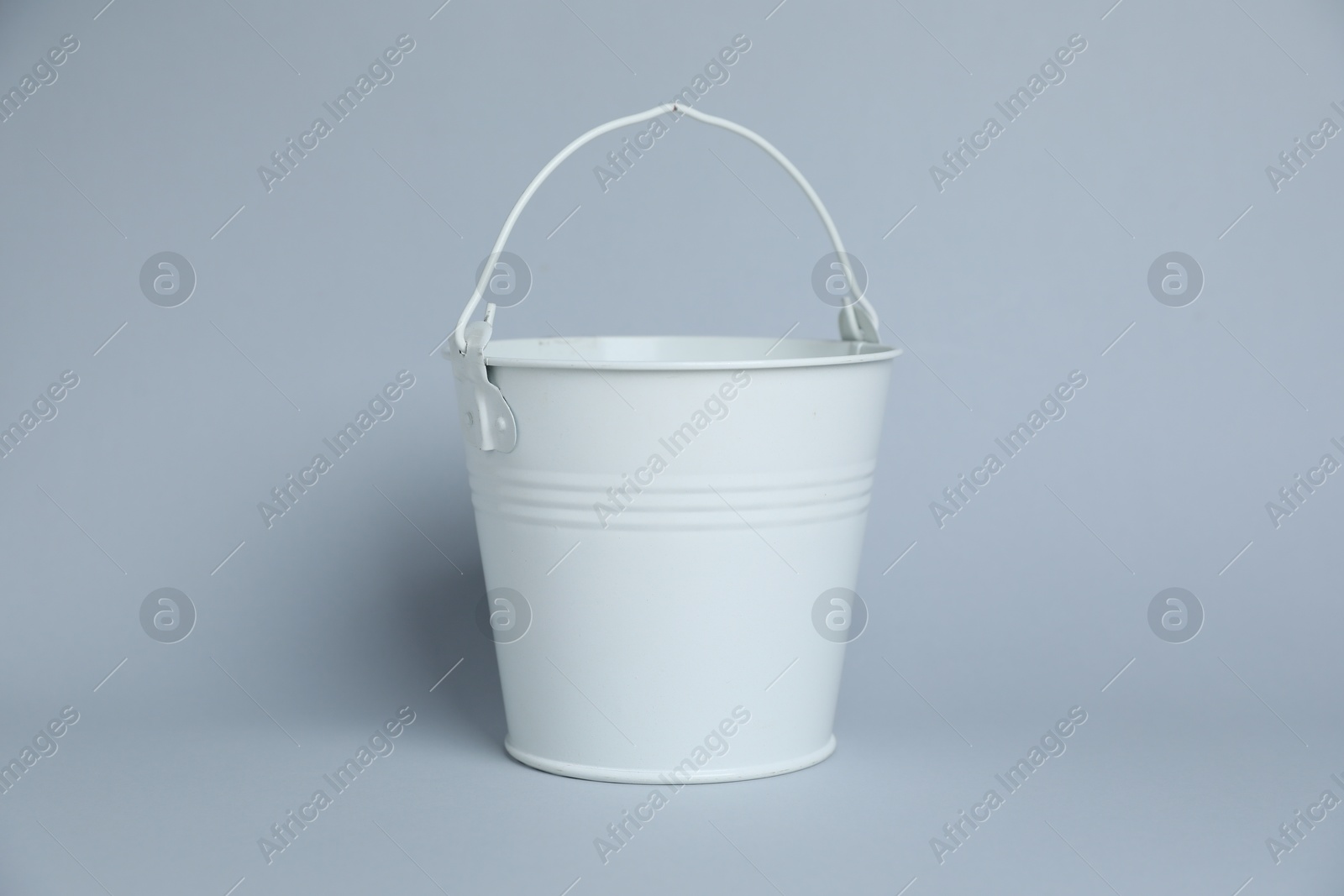 One white bucket on light grey background Photo of One white bucket on light grey background