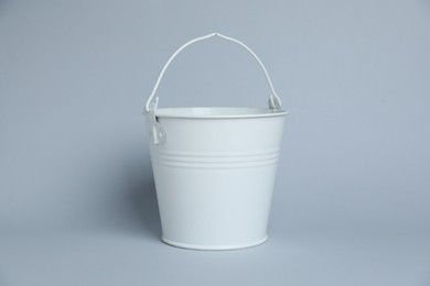 Photo of One white bucket on light grey background
