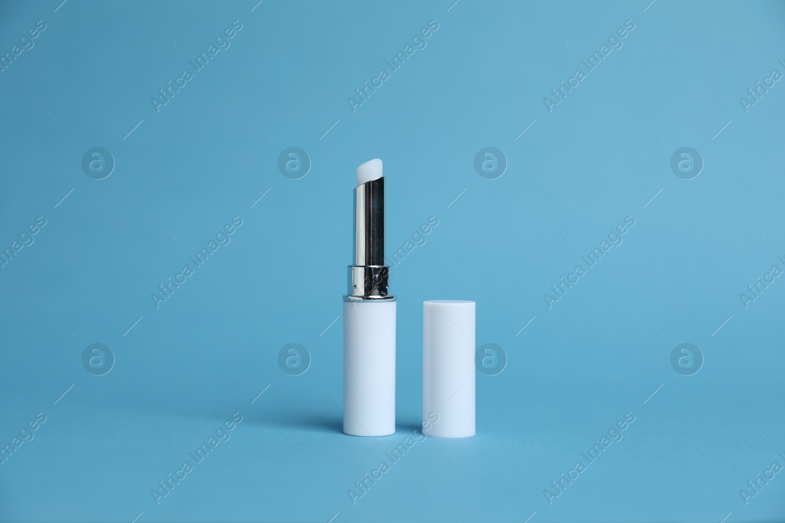 One white lipstick on light blue background Photo of One white lipstick on light blue background