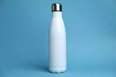 Photo of One white water bottle on light blue background