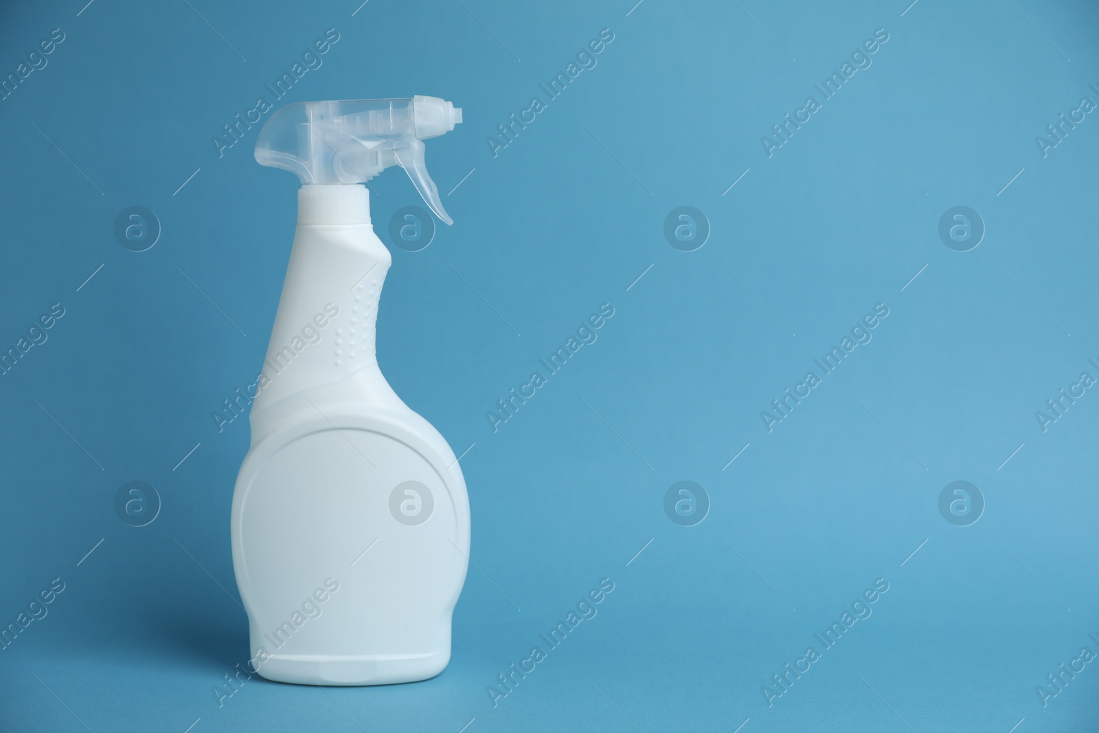White spray bottle of cleaning product on light blue background, space for text Photo of White spray bottle of cleaning product on light blue background, space for text