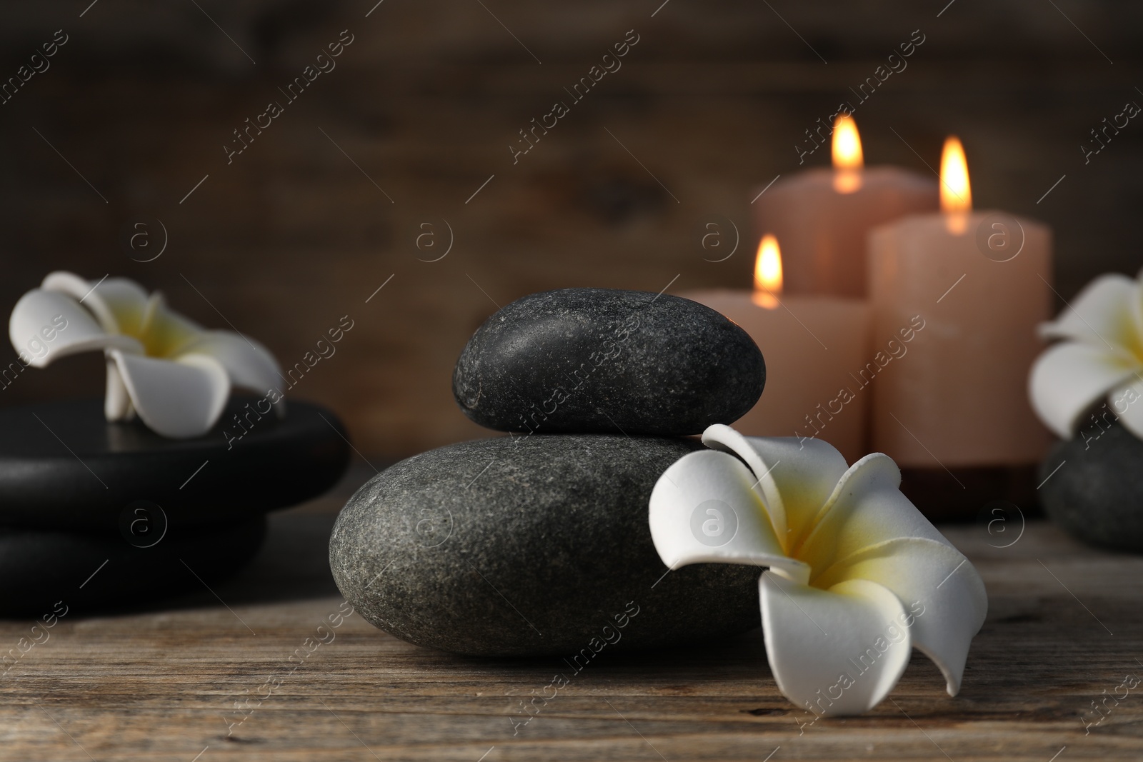 Composition with spa stones on wooden table, closeup Photo of Composition with spa stones on wooden table, closeup