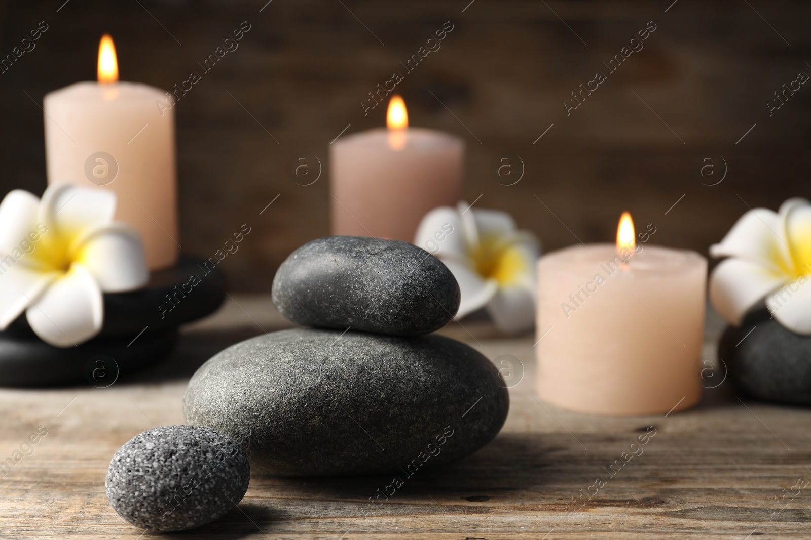 Composition with spa stones on wooden table, closeup Photo of Composition with spa stones on wooden table, closeup