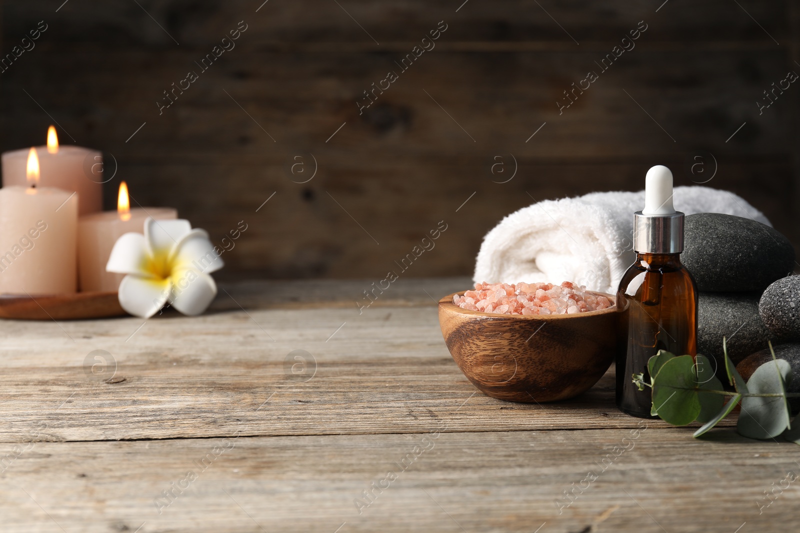 Composition with cosmetic product and spa stones on wooden table, closeup. Space for text Photo of Composition with cosmetic product and spa stones on wooden table, closeup. Space for text