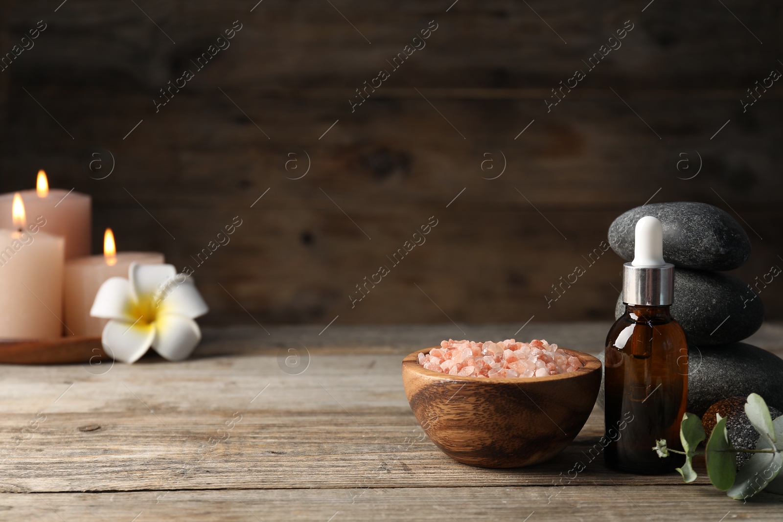 Composition with cosmetic product and spa stones on wooden table, closeup. Space for text Photo of Composition with cosmetic product and spa stones on wooden table, closeup. Space for text