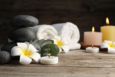 Photo of Composition with spa stones on wooden table, closeup