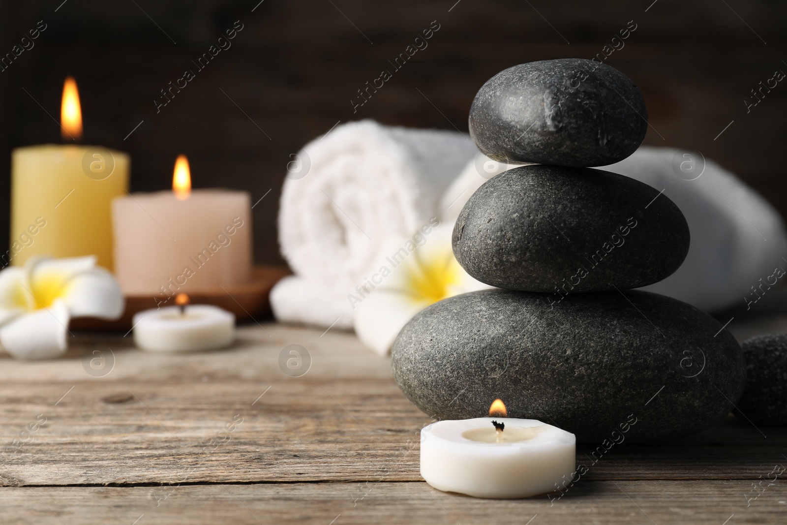 Composition with spa stones on wooden table, closeup Photo of Composition with spa stones on wooden table, closeup