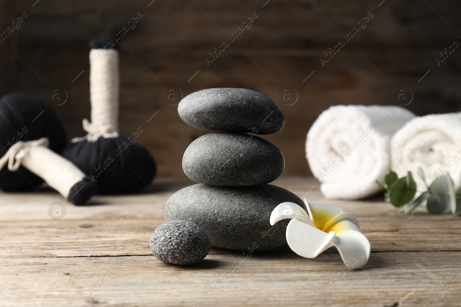 Composition with spa stones on wooden table, closeup Photo of Composition with spa stones on wooden table, closeup