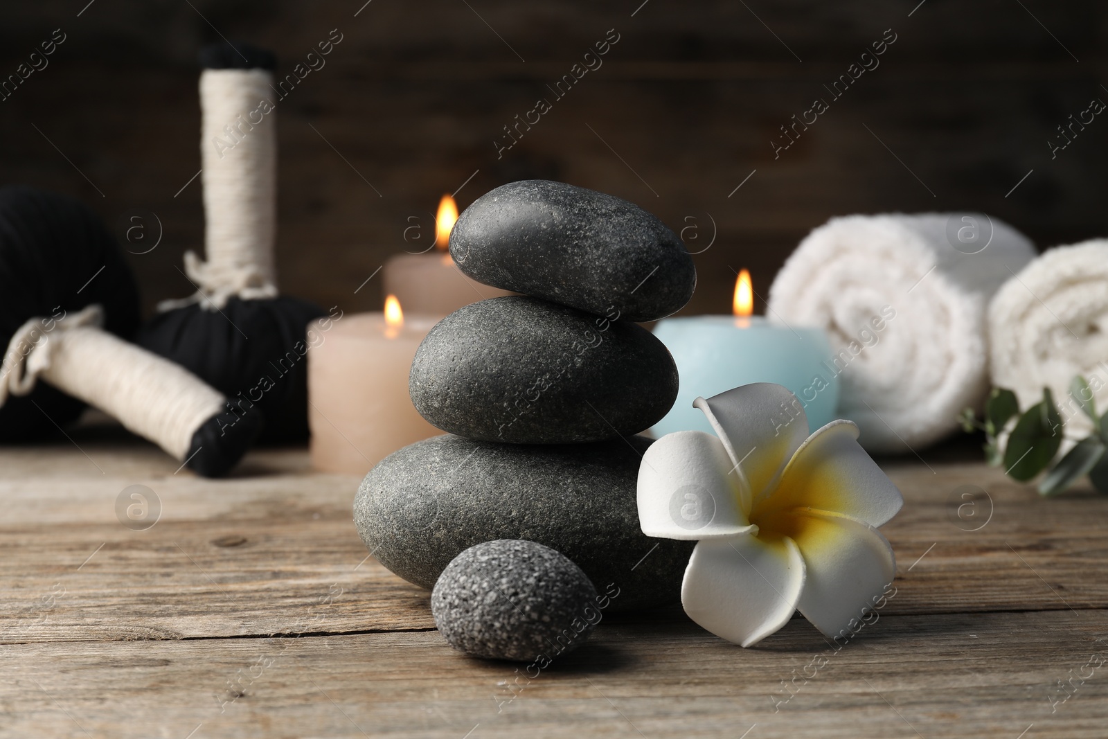 Composition with spa stones on wooden table, closeup Photo of Composition with spa stones on wooden table, closeup