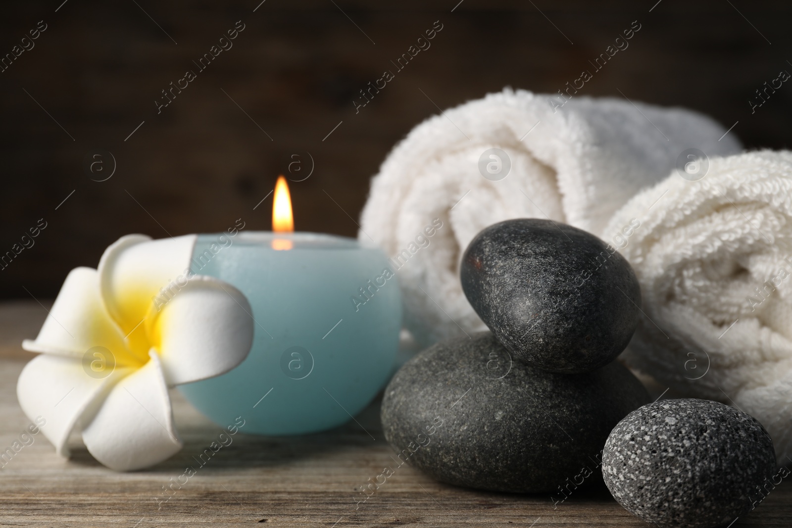 Composition with spa stones on wooden table, closeup Photo of Composition with spa stones on wooden table, closeup