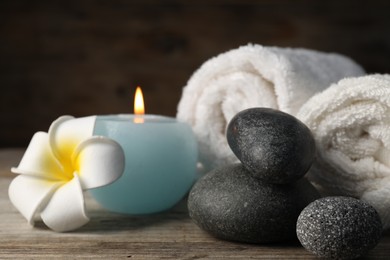 Photo of Composition with spa stones on wooden table, closeup