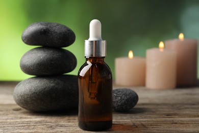 Photo of Spa stones and cosmetic product on wooden table, closeup