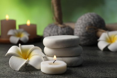 Photo of Composition with spa stones on grey table, closeup