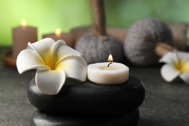 Photo of Composition with spa stones on grey table, closeup