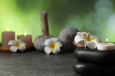 Photo of Composition with spa stones on grey table, closeup