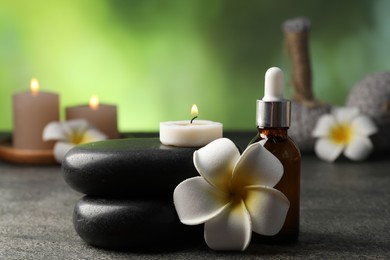 Photo of Composition with spa stones on grey table, closeup
