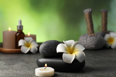 Photo of Composition with spa stones on grey table, closeup