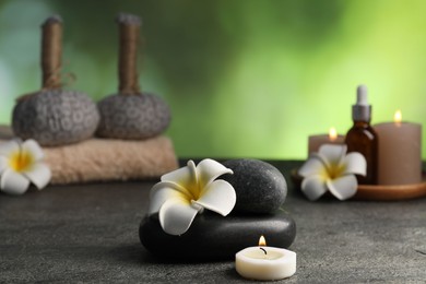 Photo of Composition with spa stones on grey table, closeup