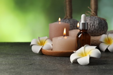 Photo of Composition with burning candles and herbal bags on grey table, closeup. Space for text
