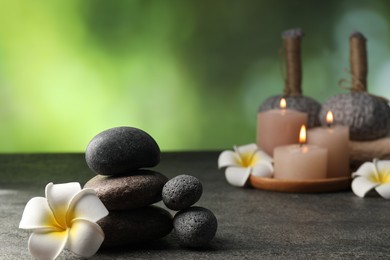 Photo of Composition with spa stones on grey table, closeup. Space for text