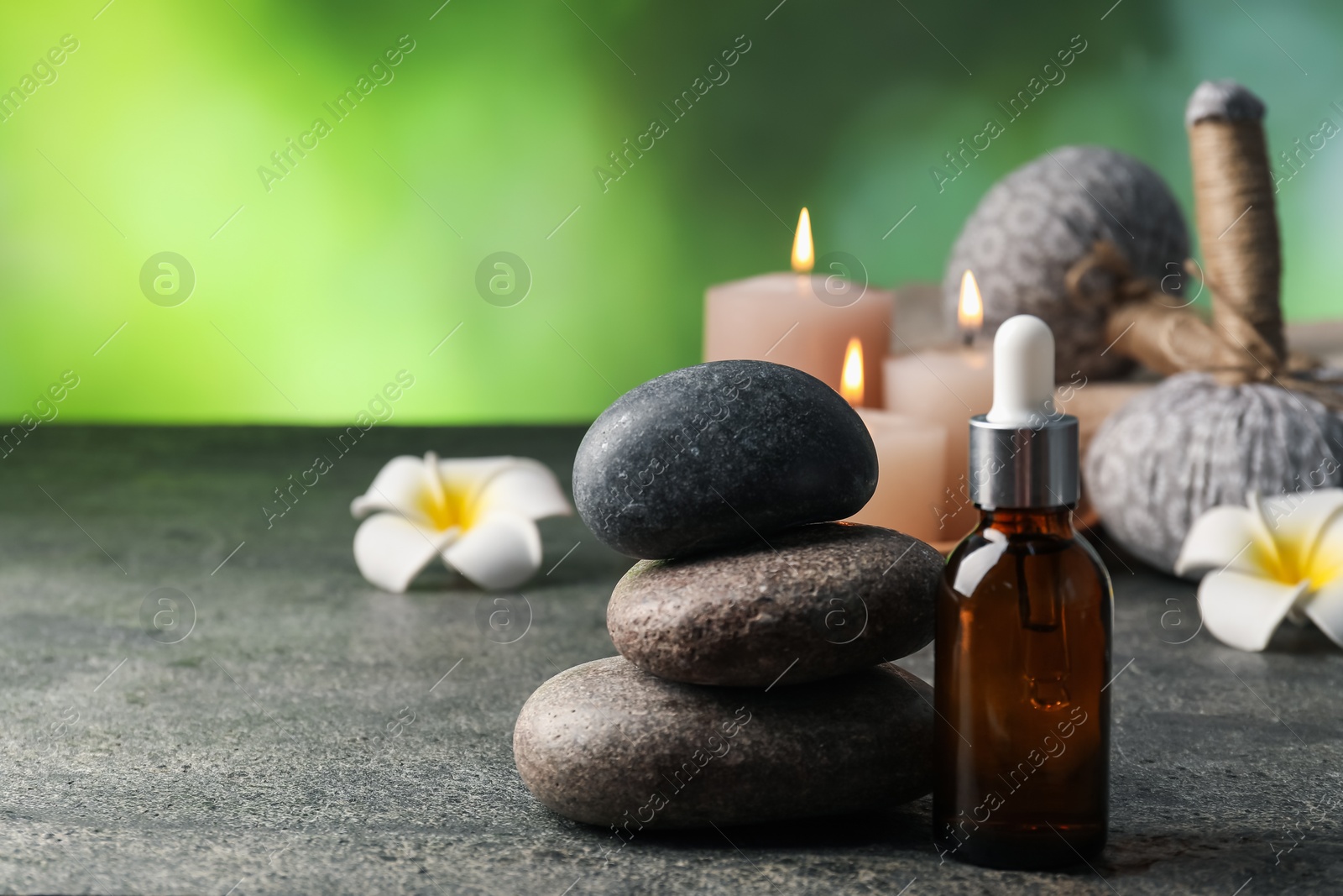 Composition with spa stones on grey table, closeup. Space for text Photo of Composition with spa stones on grey table, closeup. Space for text