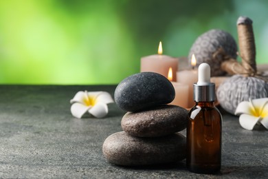 Photo of Composition with spa stones on grey table, closeup. Space for text