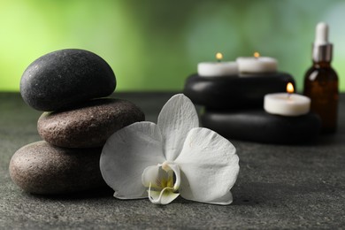 Photo of Composition with spa stones on grey table, closeup