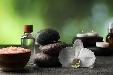 Photo of Composition with spa stones on grey table, closeup