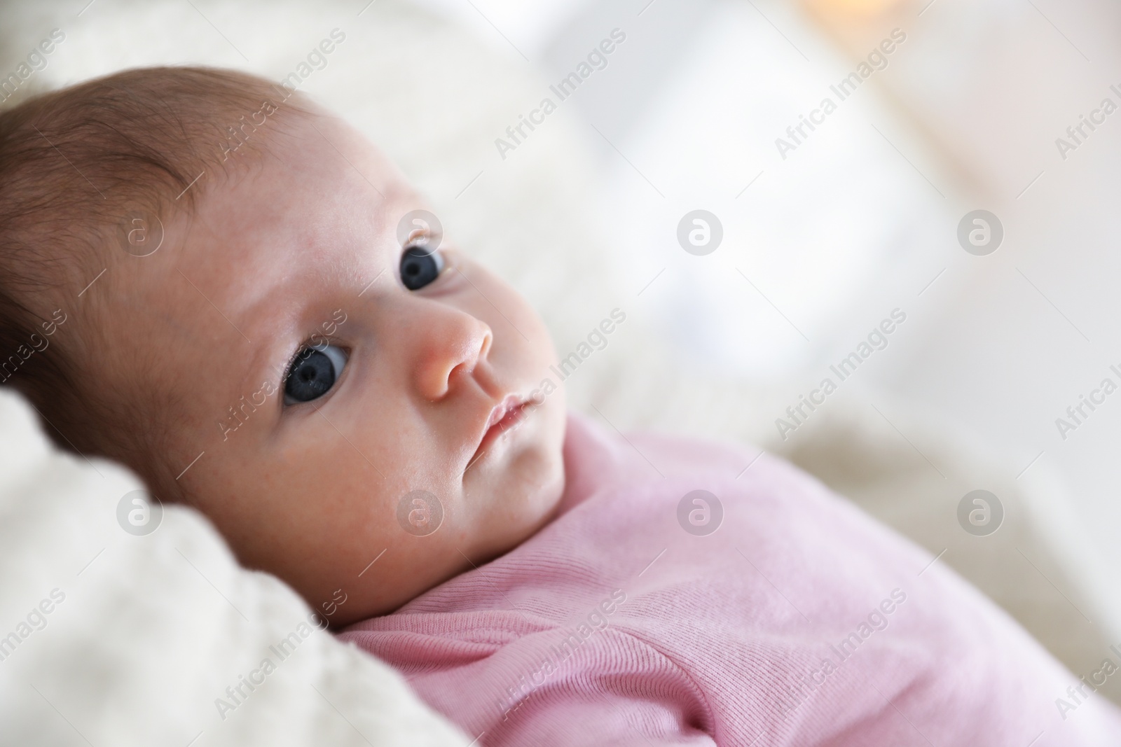 Cute newborn baby lying on bed indoors Photo of Cute newborn baby lying on bed indoors