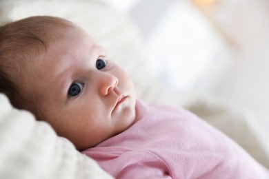 Photo of Cute newborn baby lying on bed indoors