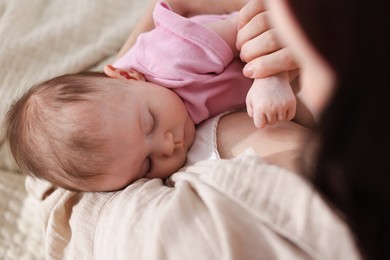 Photo of Mother with her newborn baby indoors, above view