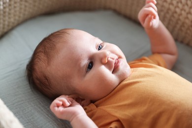 Photo of Cute newborn baby in bassinet, closeup view