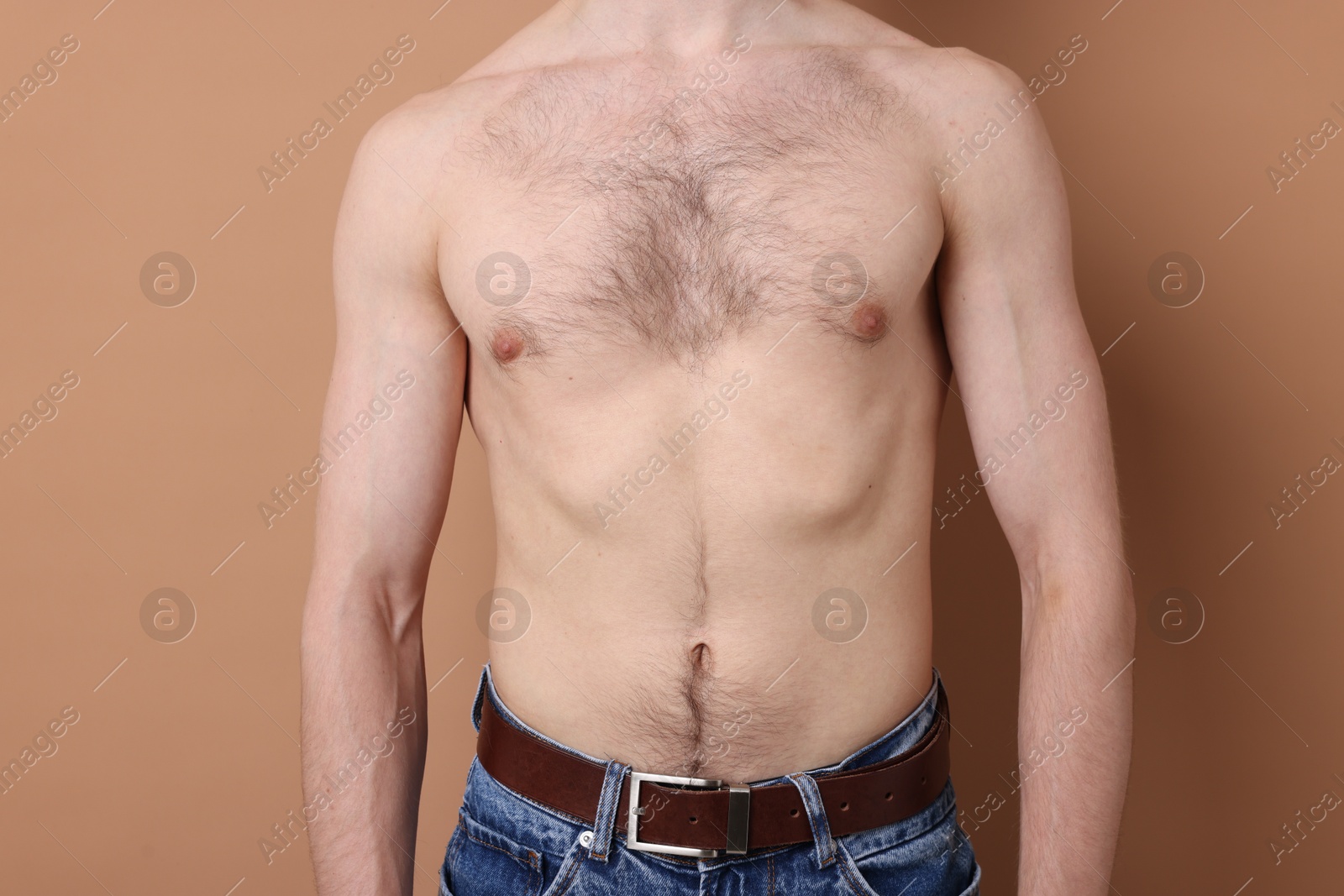 Man standing on beige background, closeup view Photo of Man standing on beige background, closeup view