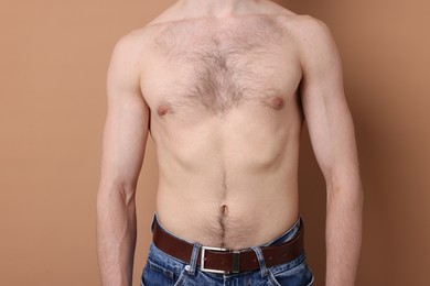 Photo of Man standing on beige background, closeup view