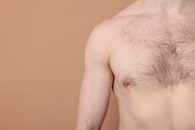 Photo of Man standing on beige background, closeup. Space for text