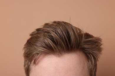 Photo of Man after hair loss treatment on beige background, closeup