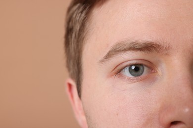 Photo of Man on beige background, closeup. Space for text