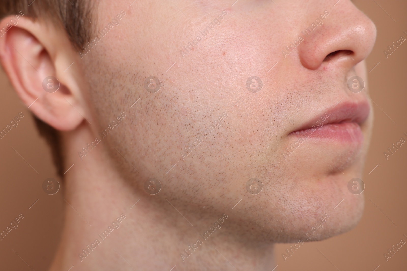 Man after shaving on beige background, closeup Photo of Man after shaving on beige background, closeup