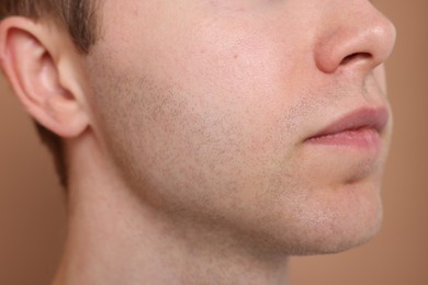 Photo of Man after shaving on beige background, closeup