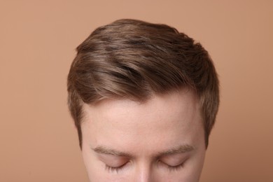 Photo of Man after hair loss treatment on beige background, closeup