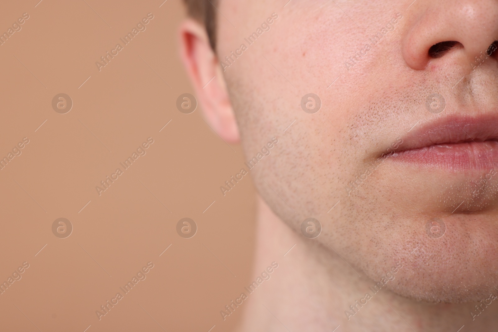 Man after shaving on beige background, closeup. Space for text Photo of Man after shaving on beige background, closeup. Space for text