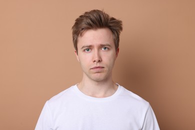 Photo of Handsome man after shaving on beige background