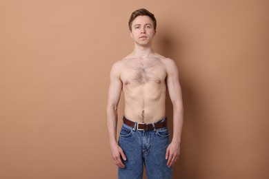 Photo of Man after scoliosis treatment on beige background
