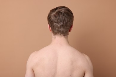 Photo of Man after scoliosis treatment on beige background, back view