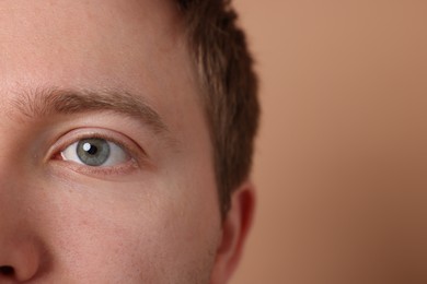 Photo of Man on beige background, closeup. Space for text